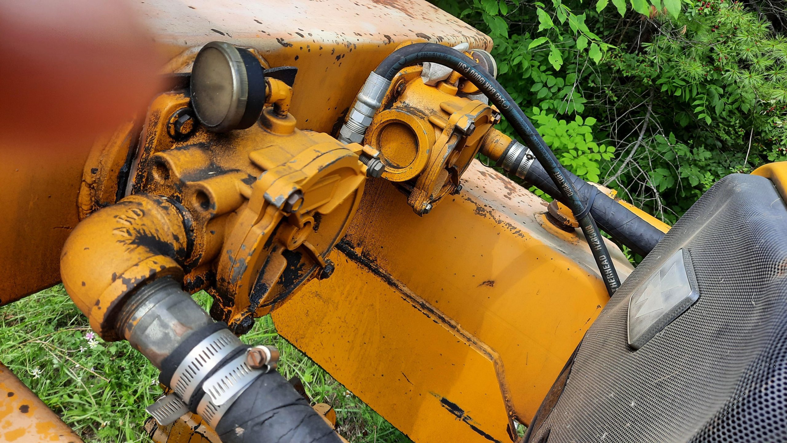 A hose clamp securing a hydraulic line to a machine frame
