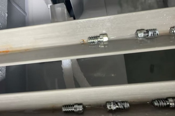 Screws inside a test rack after a salt spray test